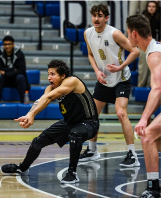 A Men's Volleyball player digging a hard hit ball